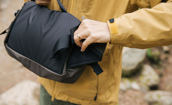Person tucking away the padded hip belt.